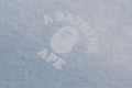 A BATHING APE Ladies' INDIGO COLLEGE PRINT BOXY CROPPED LS TEE