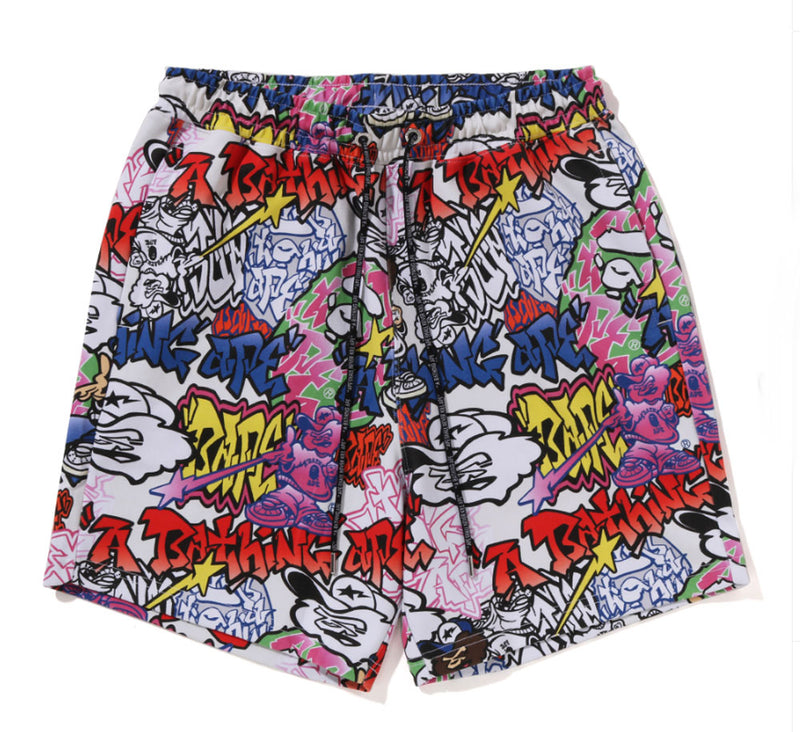 A BATHING APE GRAFFITI PATTERN BEACH SHORTS