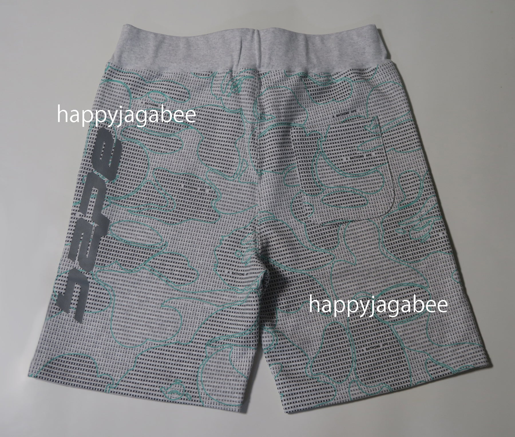 A BATHING APE TEXT CODE CAMO SWEAT SHORTS